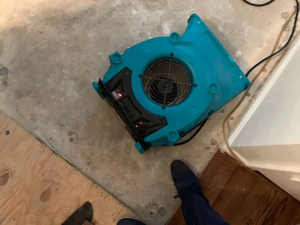 Air mover drying subfloor during Commercial Water Damage Restoration in North Bay Village